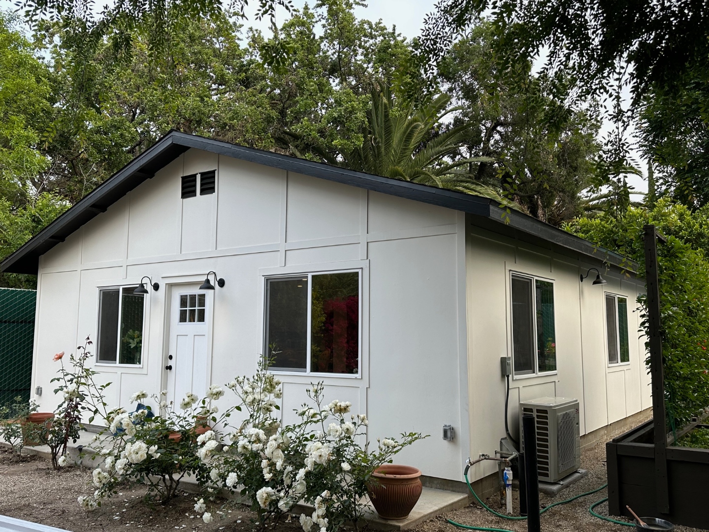 Side angle view of detached ADU showing full footprint and rose garden