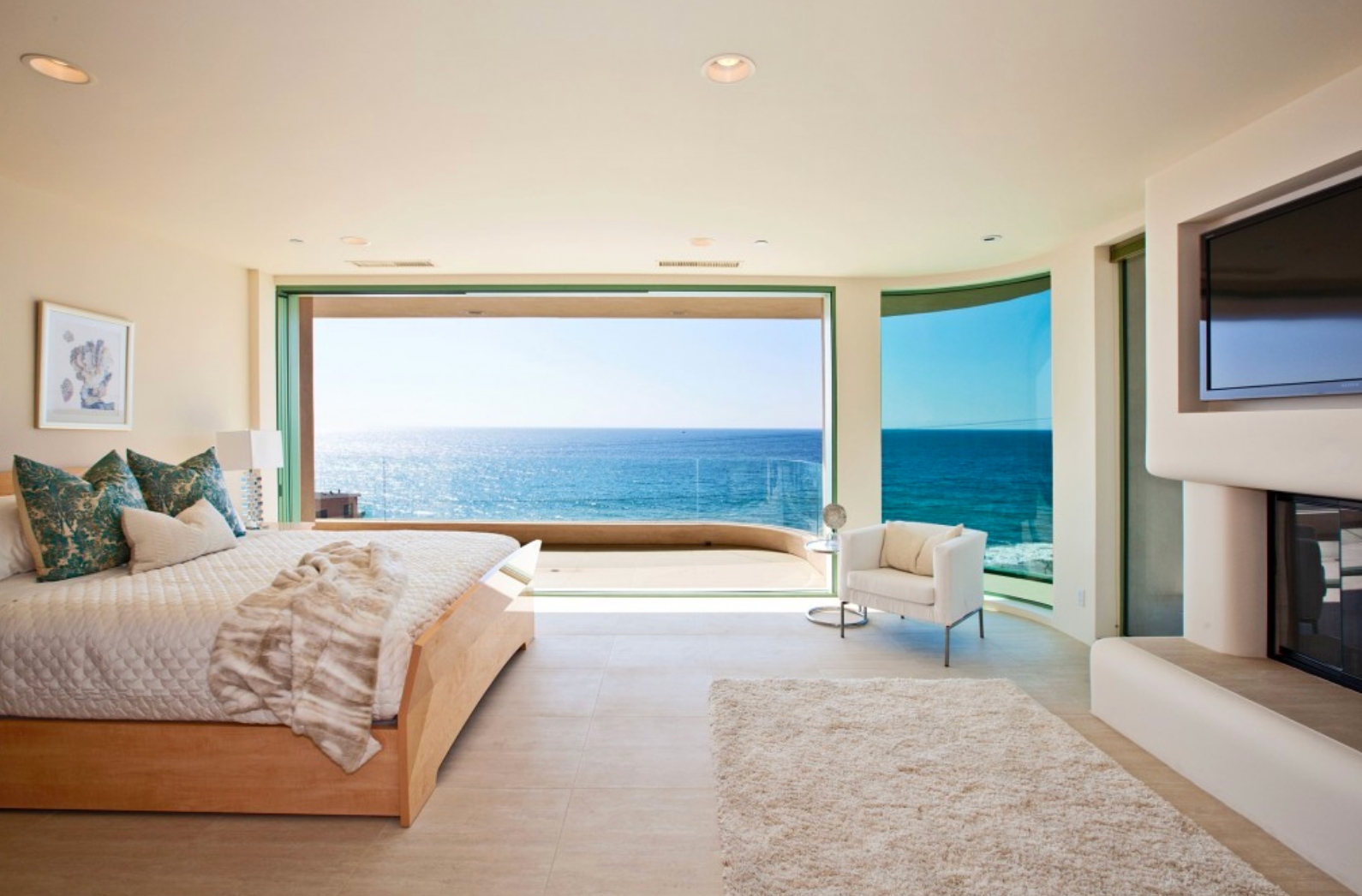 Ocean view master bedroom with floor-to-ceiling glass